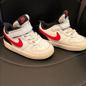 Nike Kids White Sneakers with Red Swoosh and Black Accents